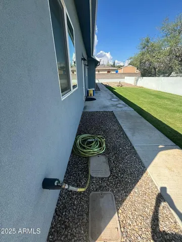 a view of a pathway of a house with a yard