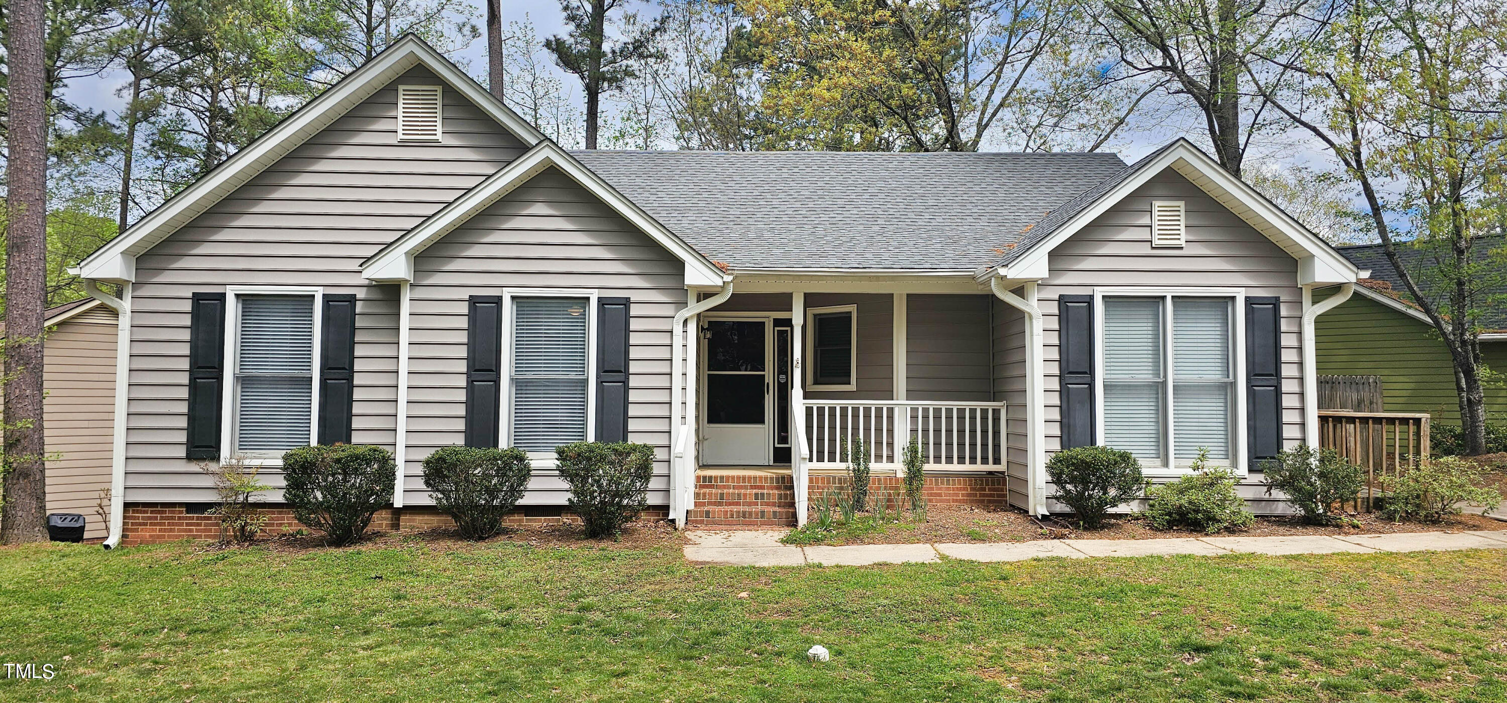 a front view of a house with a yard and porch