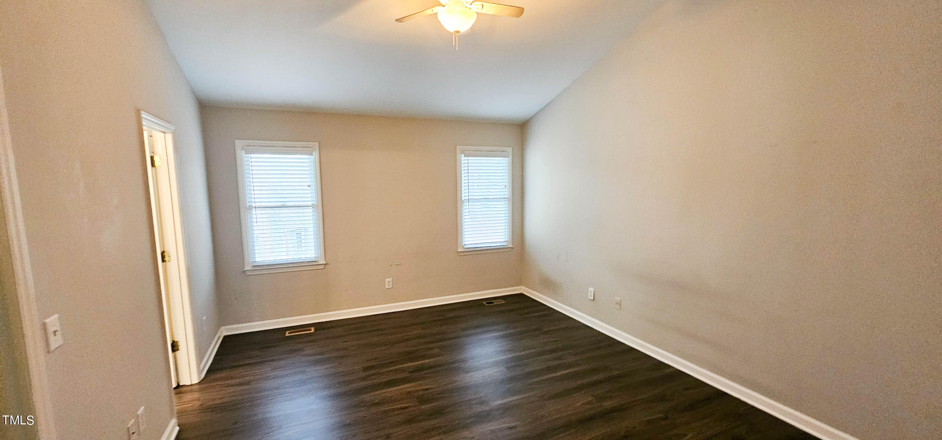 2141 Leadenhall Way Raleigh, NC 27603 - Photo 11 of 24 an empty room with wooden floor and windows