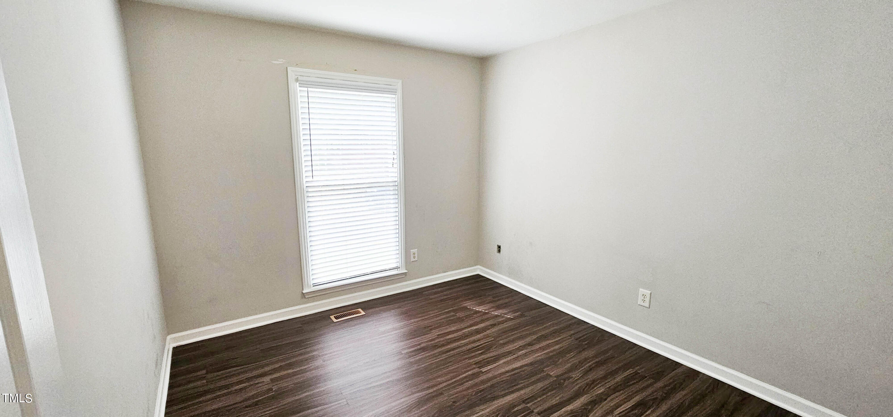 2141 Leadenhall Way Raleigh, NC 27603 - Photo 17 of 24 a view of an empty room with wooden floor and a window