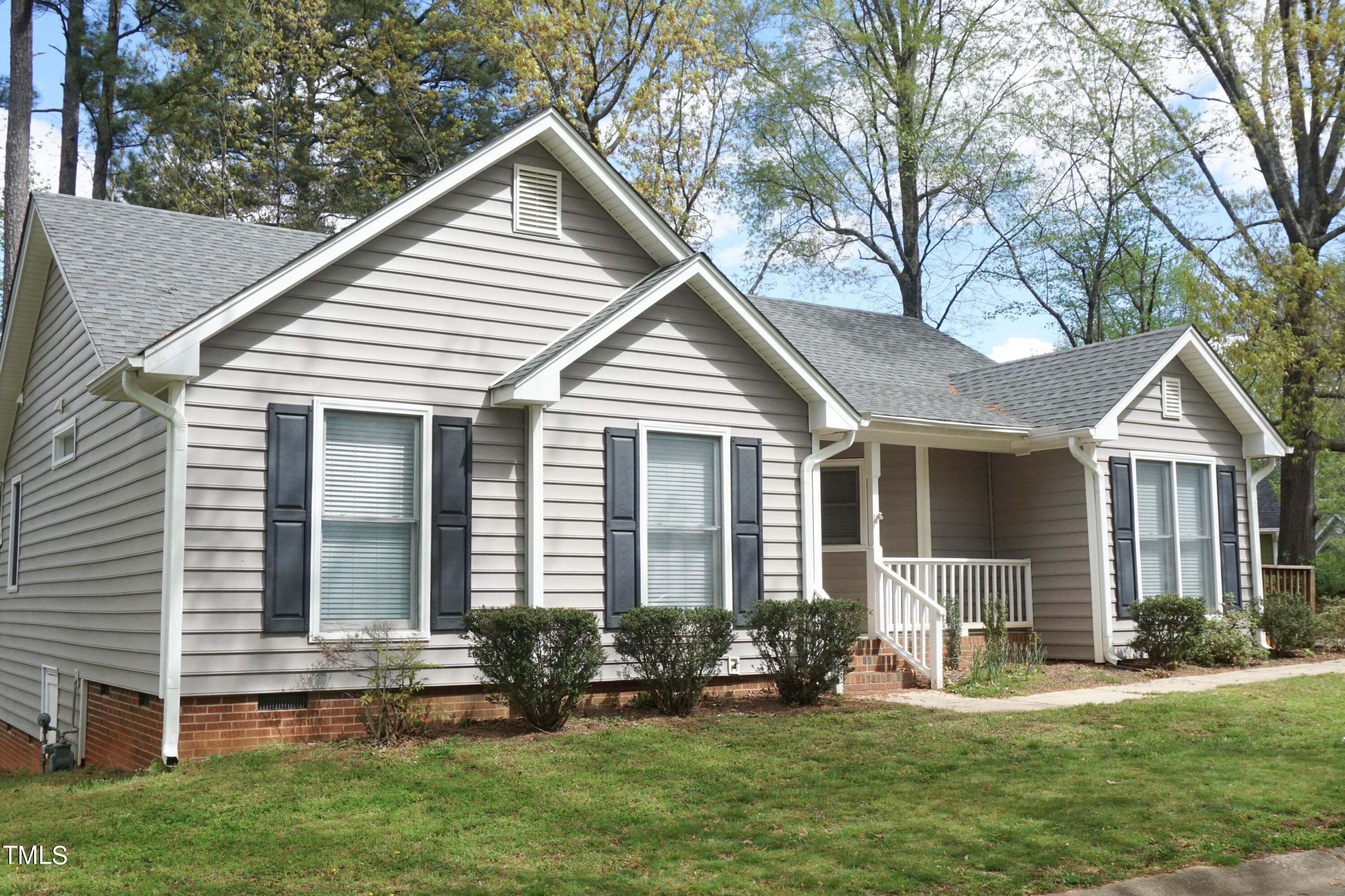 2141 Leadenhall Way Raleigh, NC 27603 - Photo 20 of 24 a front view of a house with a yard and porch