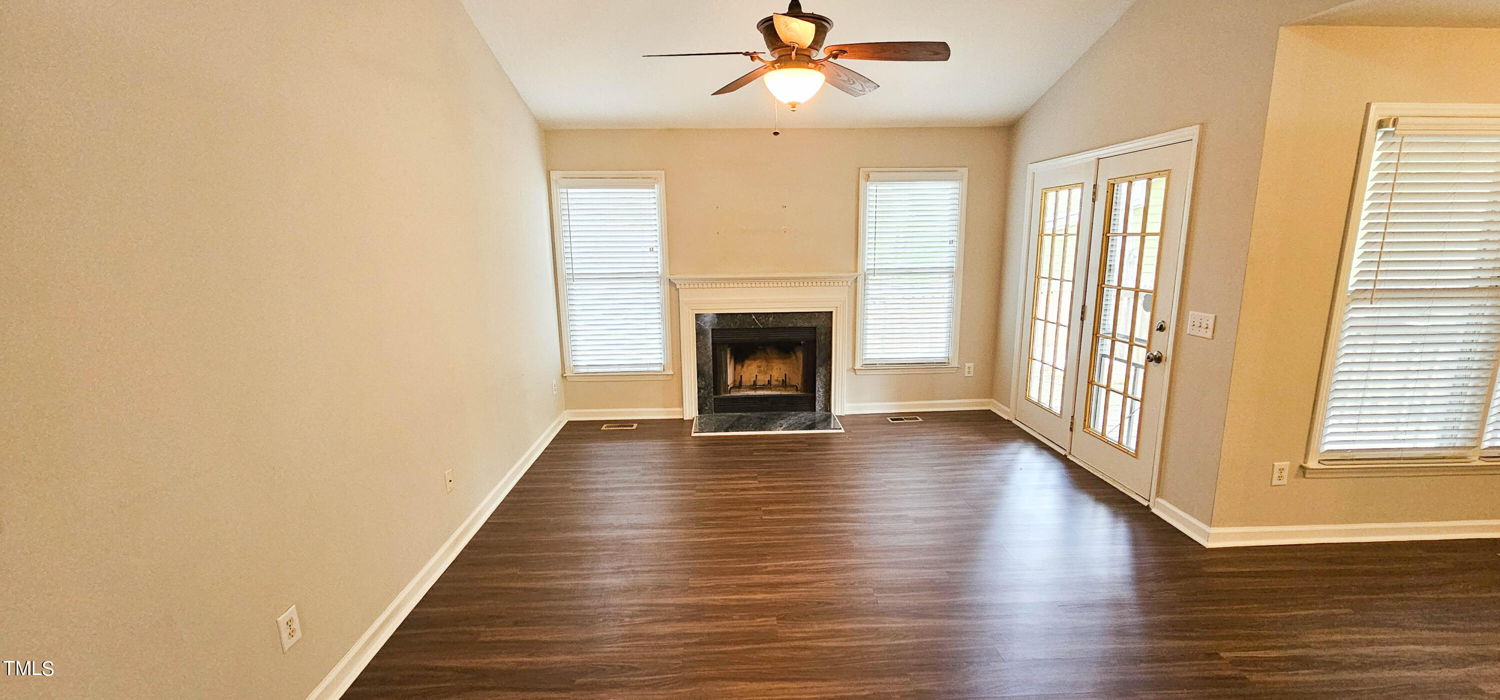 2141 Leadenhall Way Raleigh, NC 27603 - Photo 3 of 24 a view of an empty room with wooden floor fireplace and a window