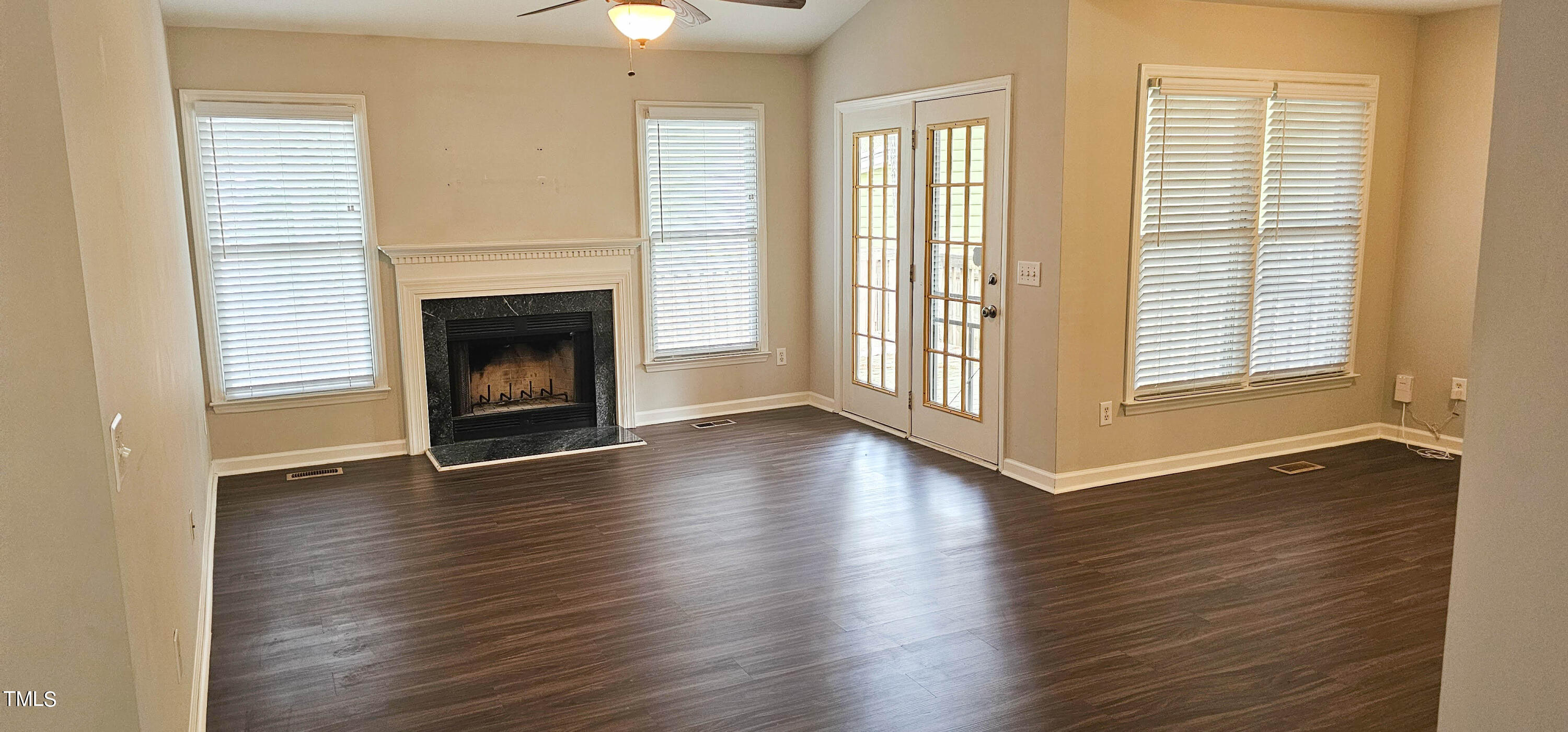 2141 Leadenhall Way Raleigh, NC 27603 - Photo 4 of 24 an empty room with wooden floor fireplace and windows
