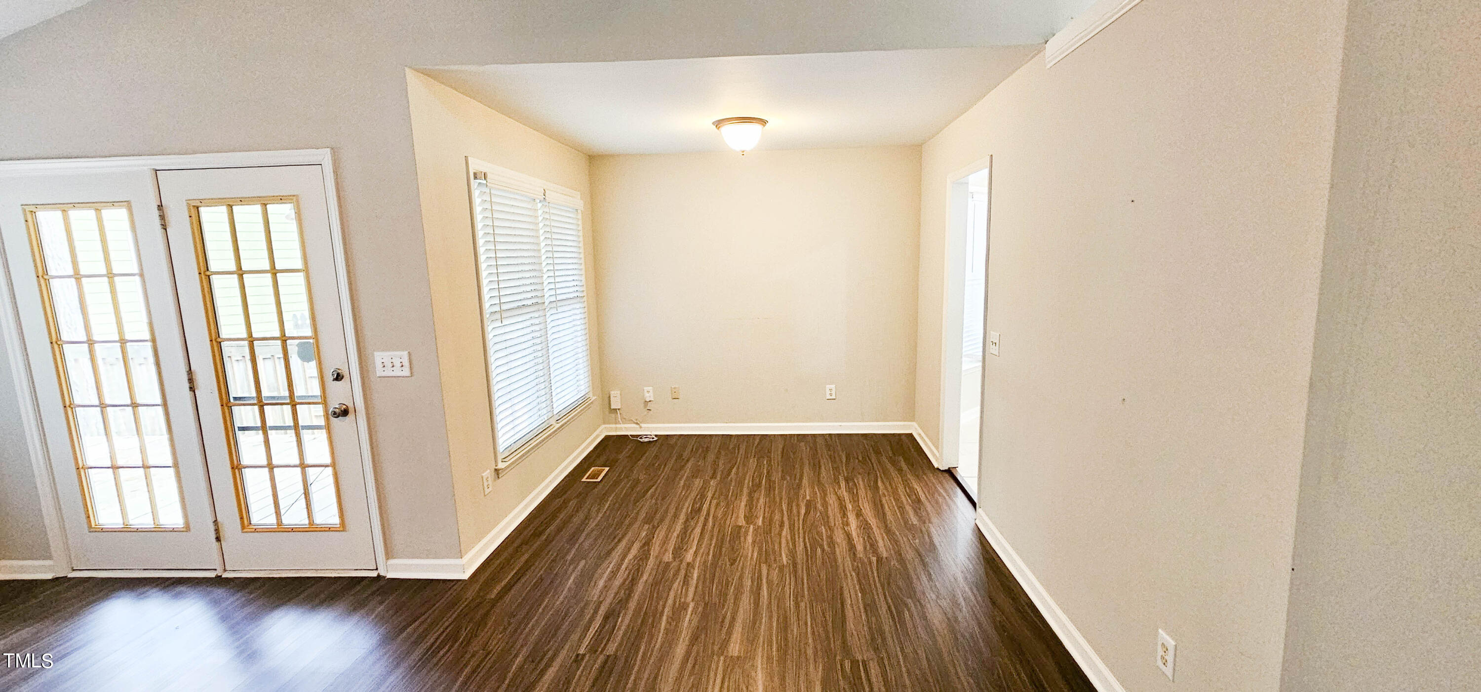 2141 Leadenhall Way Raleigh, NC 27603 - Photo 5 of 24 an empty room with wooden floor and windows
