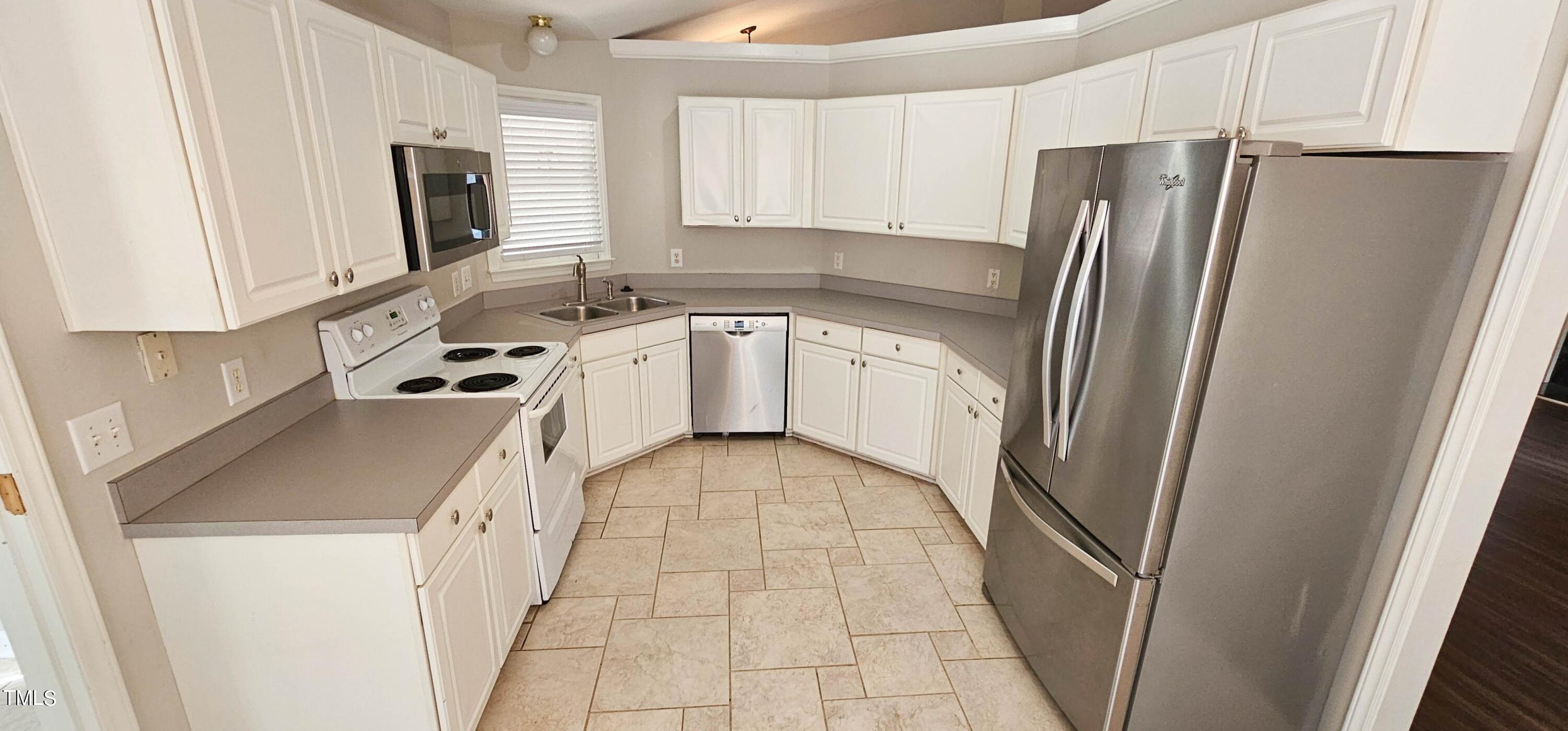 2141 Leadenhall Way Raleigh, NC 27603 - Photo 7 of 24 a kitchen with stainless steel appliances a refrigerator sink and microwave