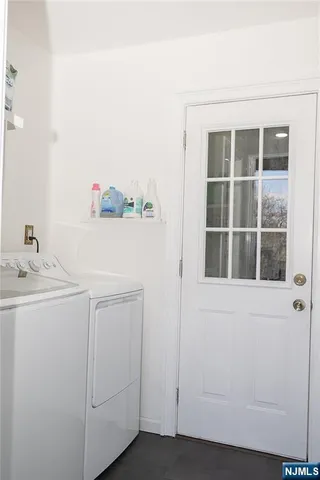 a utility room with a sink dryer and washer