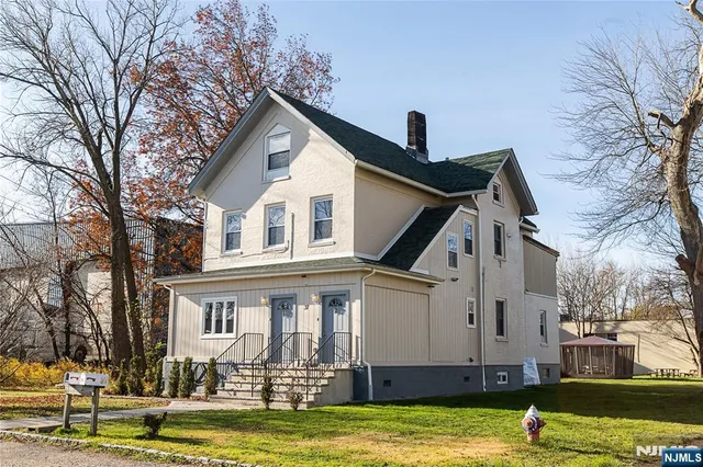 a front view of a house with a swimming pool