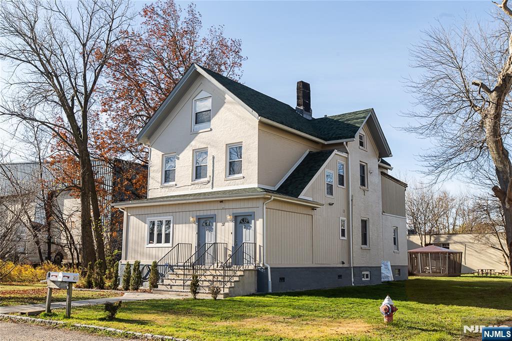 37 Riverside Avenue Little Ferry, NJ 07643 - Photo 2 of 29 a front view of a house with a swimming pool