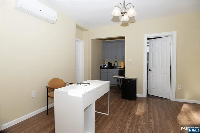 a kitchen with a refrigerator and a stove top oven