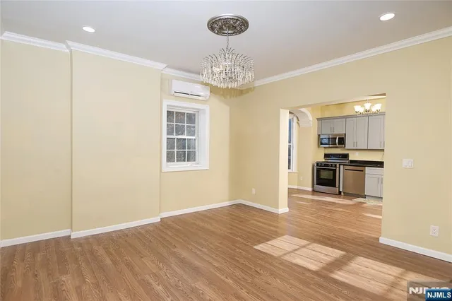a view of kitchen with granite countertop cabinets and refrigerator