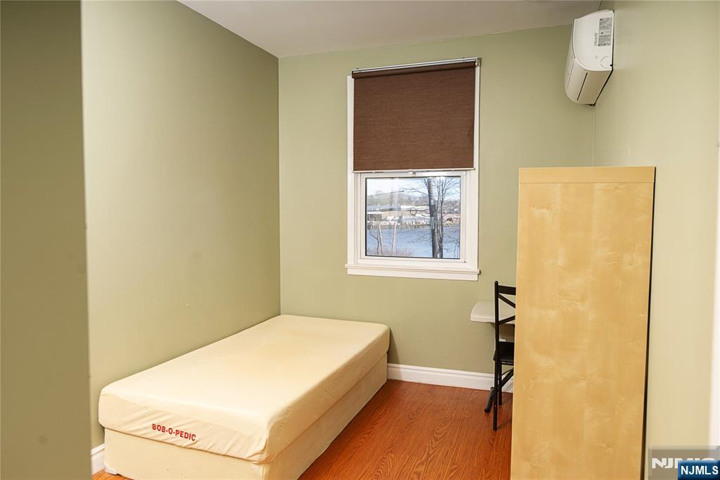 37 Riverside Avenue Little Ferry, NJ 07643 - Photo 9 of 29 a bedroom with a bed and a window