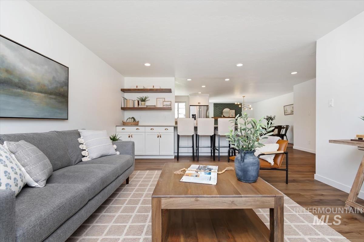 2217 North Middlefield Road Boise, ID 83704 - Photo 10 of 34 Spacious living area featuring wood-finish flooring, white walls, recessed lighting, and a built-in bar with open shelving and lower cabinetry