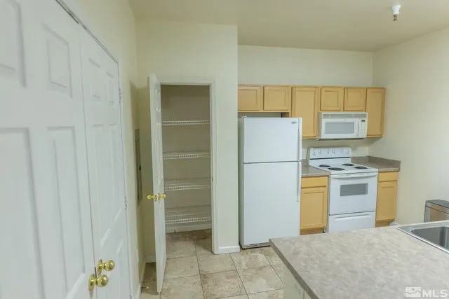 a kitchen with a refrigerator and a stove