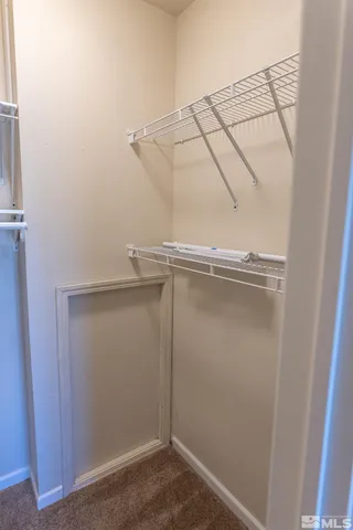 a living room with a bed furniture and a window