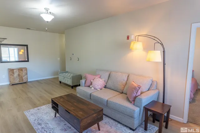 a living room with furniture and a lamp