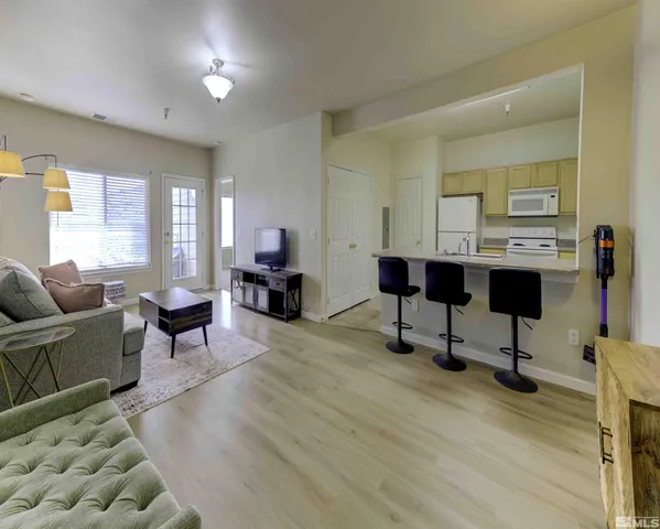 a living room with furniture a rug and a table