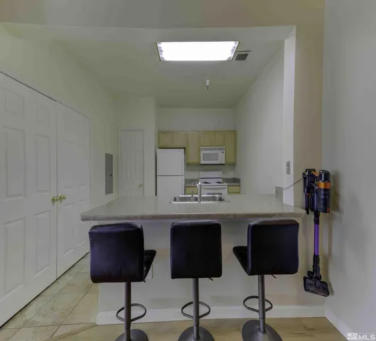 a view of a kitchen with cabinets and chair