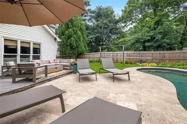 an outdoor sitting area with couch and a table