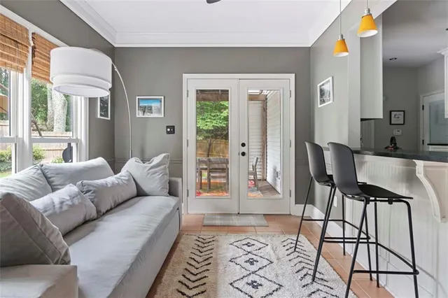 a living room with furniture and a potted plant