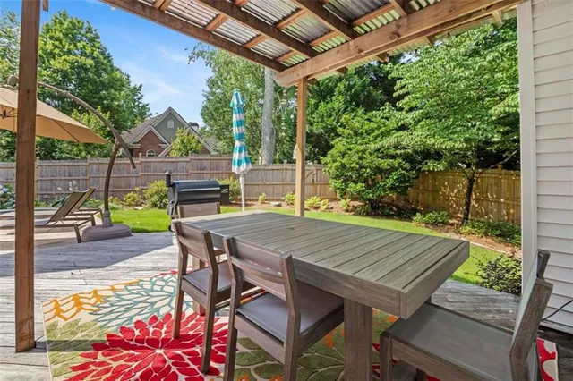 a view of a patio with table and chairs and wooden floor