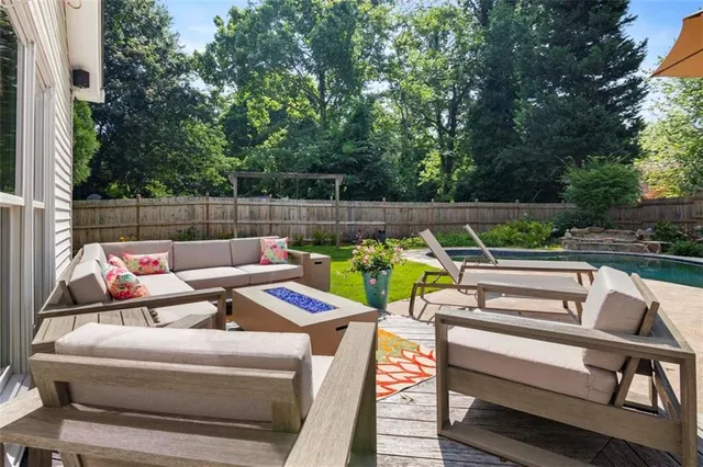 a view of a patio with couches chairs and a fire pit