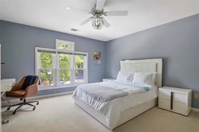 a bedroom with a bed and a chair