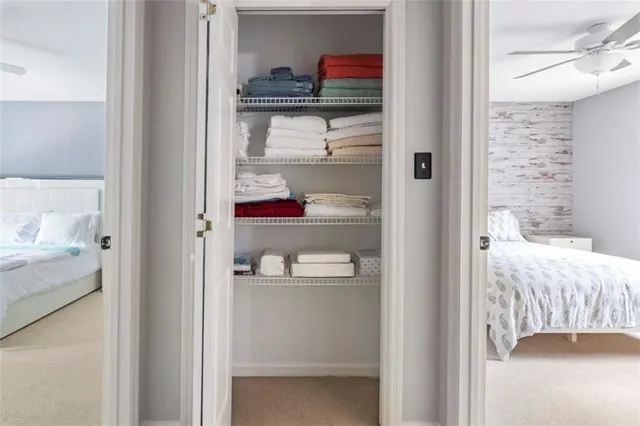 a view of a bedroom with a bed and the view of bathroom