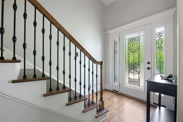 a view of an entryway with wooden floor and door