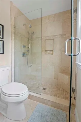 a bathroom with a toilet and a shower