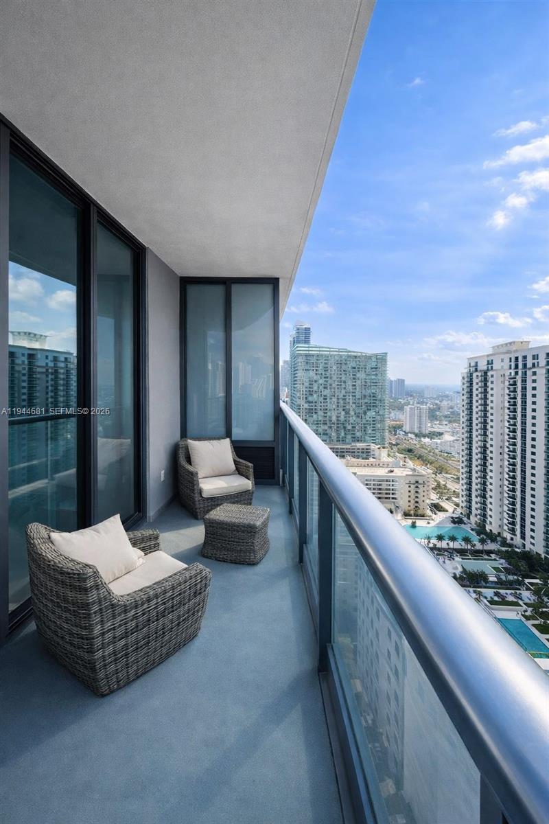 45 Southwest 9th Street, Unit 3008 Miami, FL 33130 - Photo 16 of 16 a balcony with furniture and city view