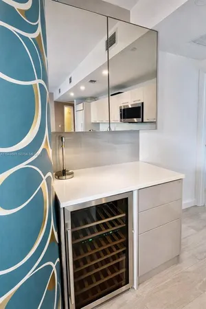 a kitchen with a sink a stove and a microwave