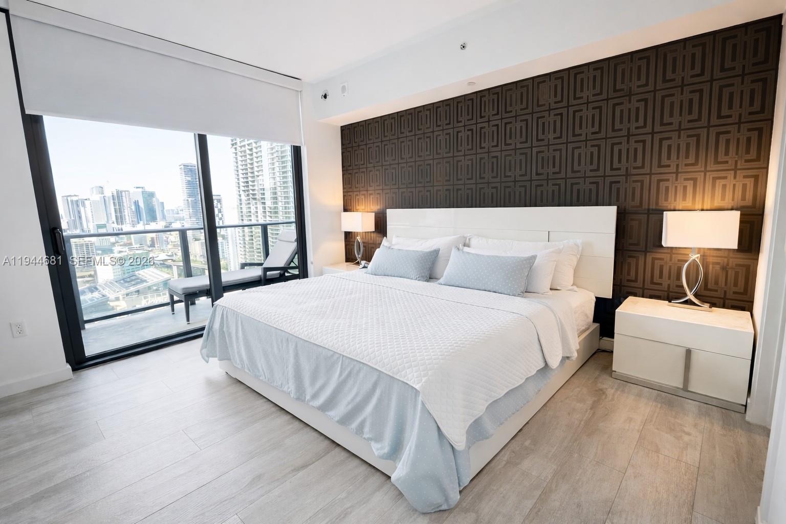 45 Southwest 9th Street, Unit 3008 Miami, FL 33130 - Photo 6 of 16 a bedroom with a bed and a large window