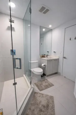 a spacious bathroom with a tub sink and mirror