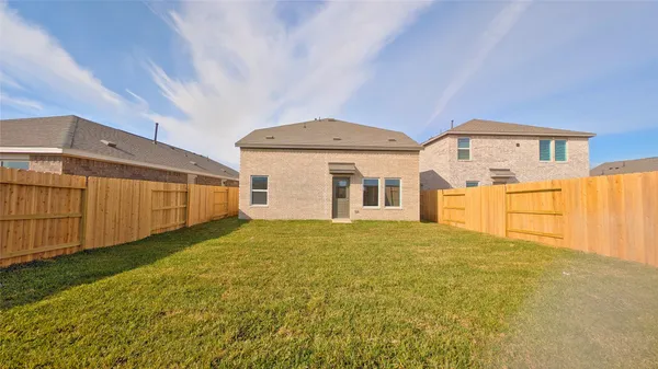 a view of an house with backyard and road