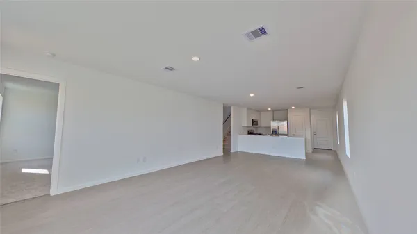 a view of a hallway with a kitchen