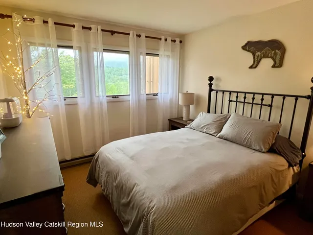 a bedroom with a bed and a mirror