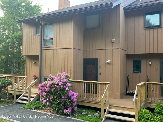 a view of a house with a yard and sitting area