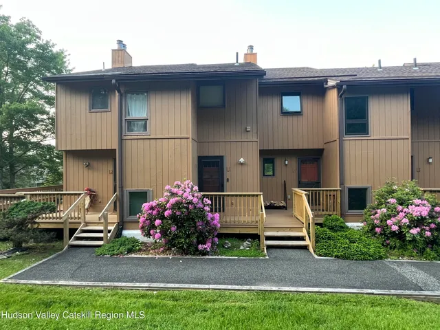 a backyard of a house with fountain table and chairs