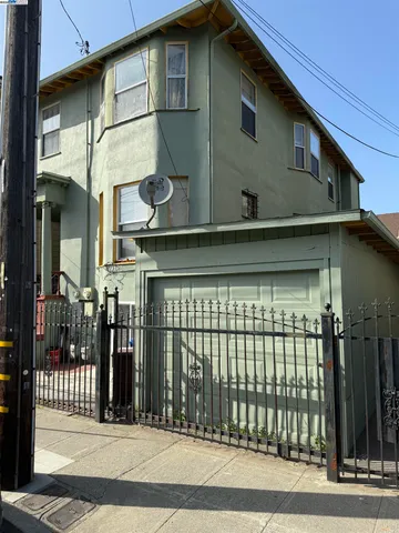a view of a house with a iron gate