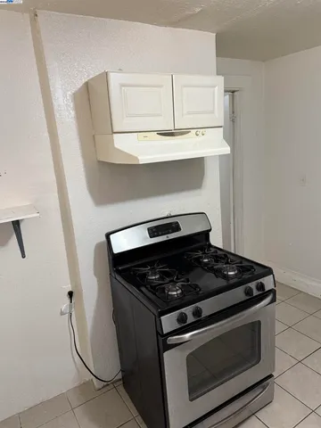 a stove top oven sitting inside of a kitchen