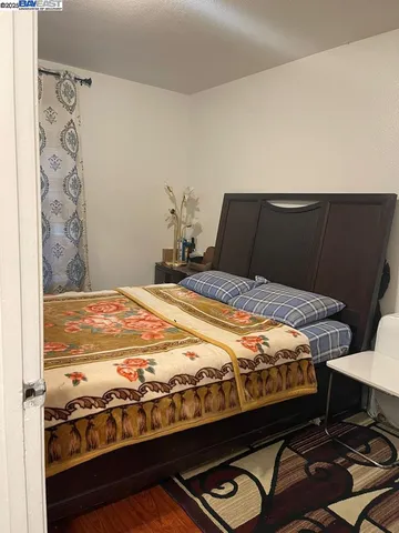 a bedroom with a bed and dresser