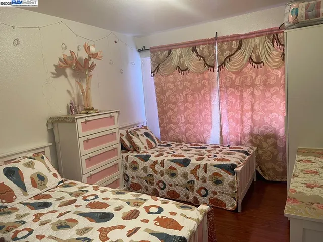 a bedroom with a bed and a painting on the wall