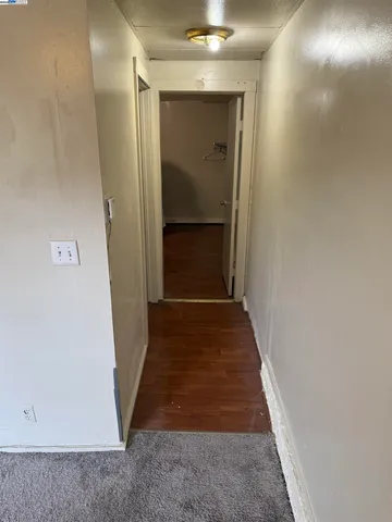 wooden floor in a hallway with a door