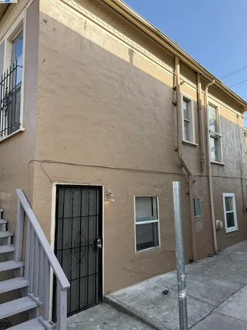 a view of a brick house with many windows