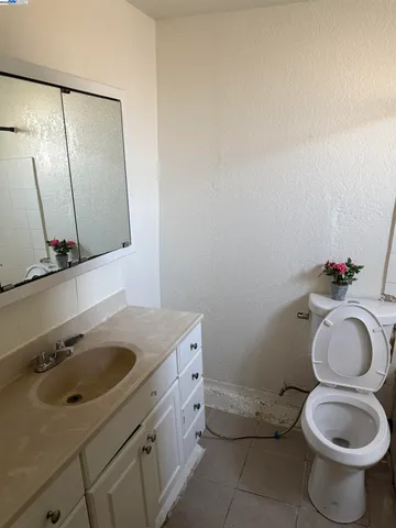 a bathroom with a sink toilet and mirror