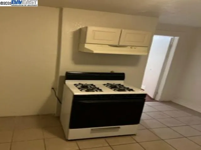 a stove top oven sitting inside of a kitchen