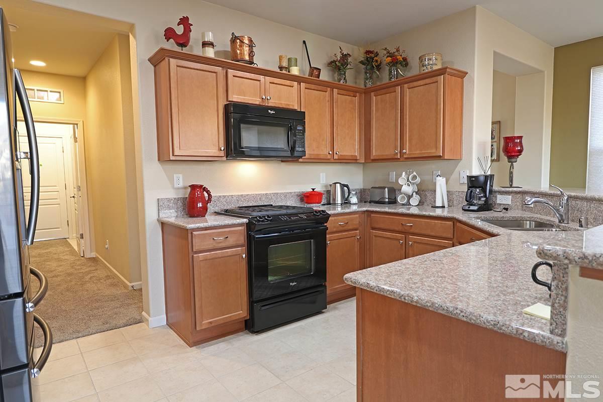 1142 Callaway Trail Reno, NV 89523 - Photo 6 of 21 a kitchen with stainless steel appliances granite countertop a sink stove and cabinets