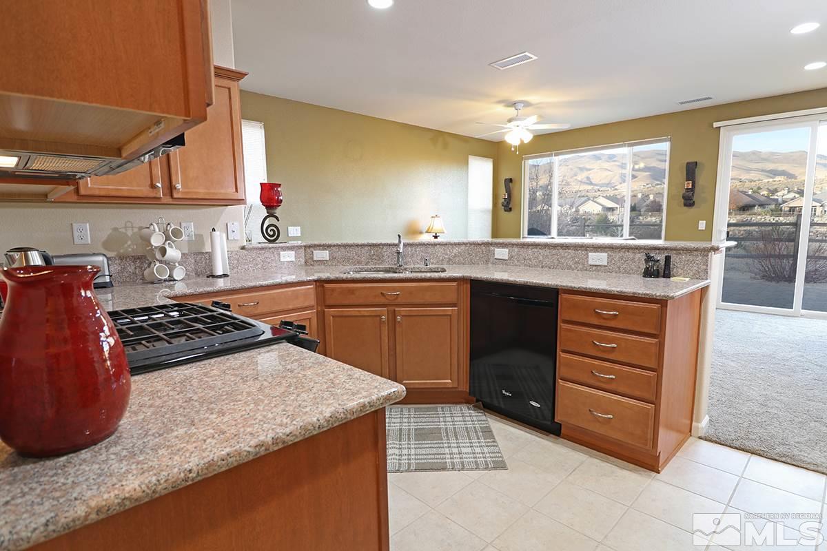 1142 Callaway Trail Reno, NV 89523 - Photo 8 of 21 a kitchen with a stove a sink and a refrigerator