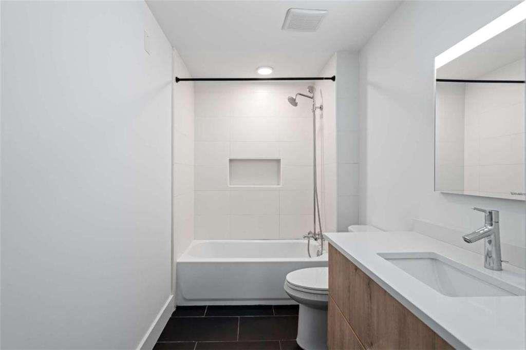 346 Peters Street Southwest, Unit 308 Atlanta, GA 30313 - Photo 16 of 19 a bathroom with a sink toilet and shower