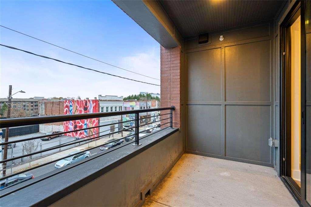 346 Peters Street Southwest, Unit 308 Atlanta, GA 30313 - Photo 19 of 19 a view of a balcony with wooden benches